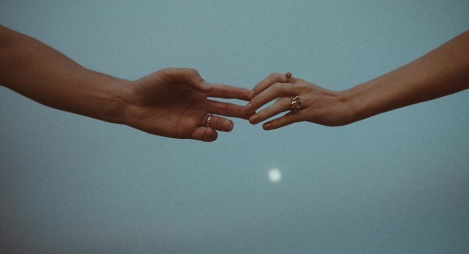 two hands barely touching