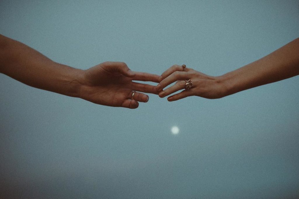 two hands barely touching